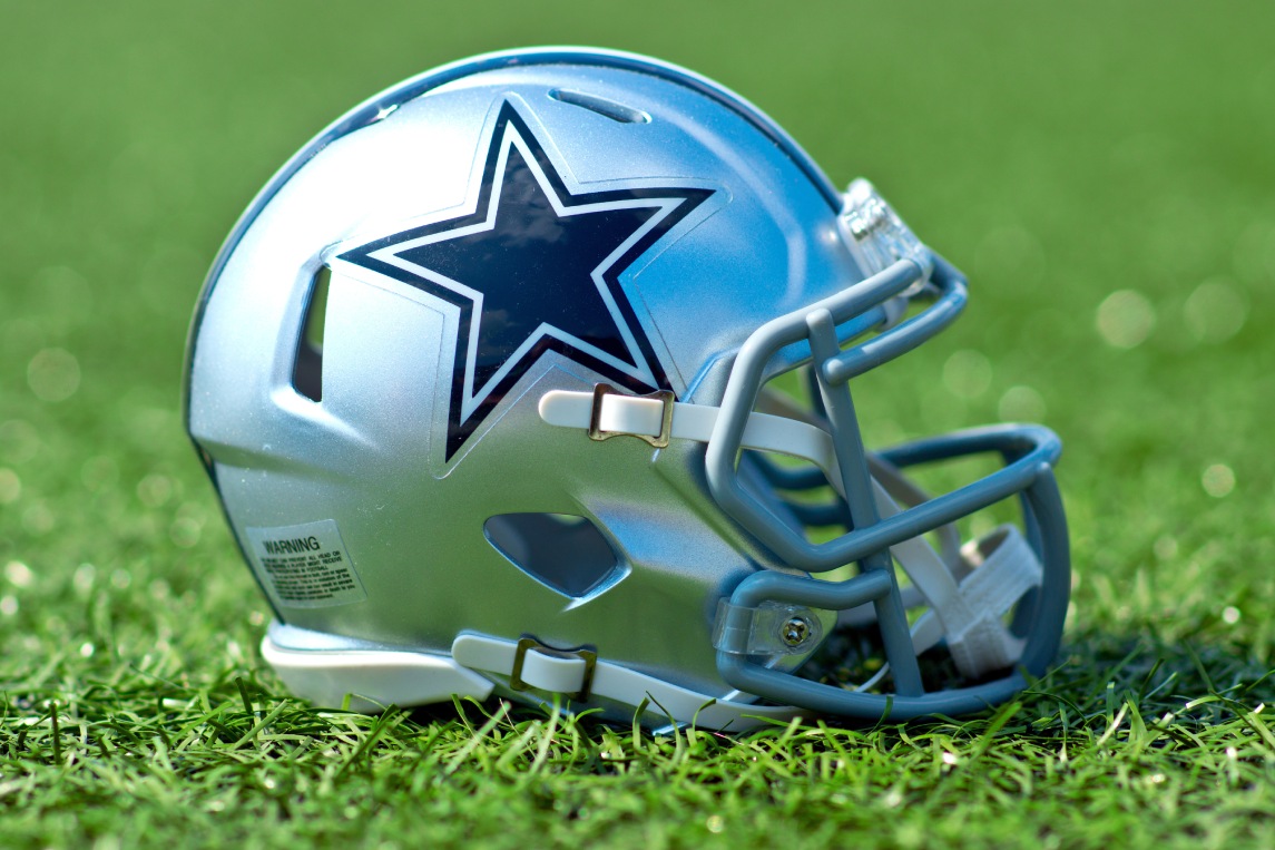 NFL Dallas Cowboys replica helmet on artificial grass playing turf , product shot