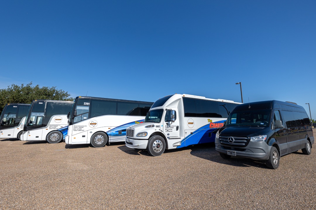 A group of tour buses parked next to each other